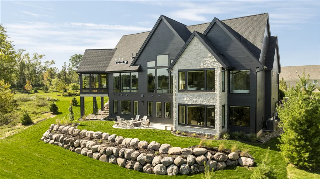 Upscale suburban bungalow with a green lawn and wooden architecture.