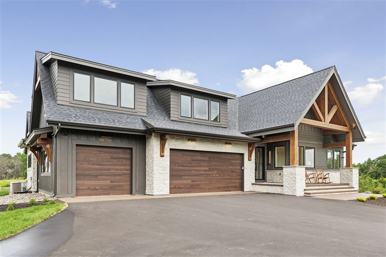 Luxury suburban home with garage and driveway