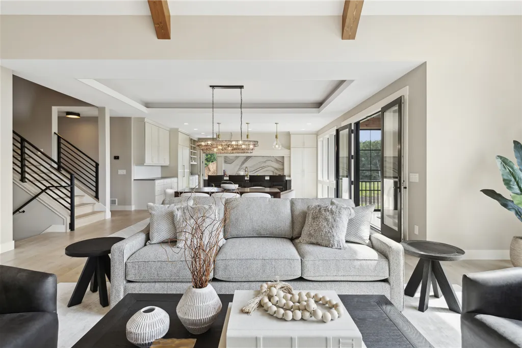 Luxurious minimalist living room with contemporary furniture and large windows.