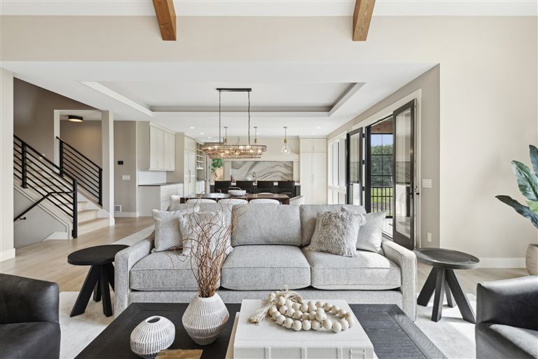 Luxurious minimalist living room with contemporary furniture and large windows.