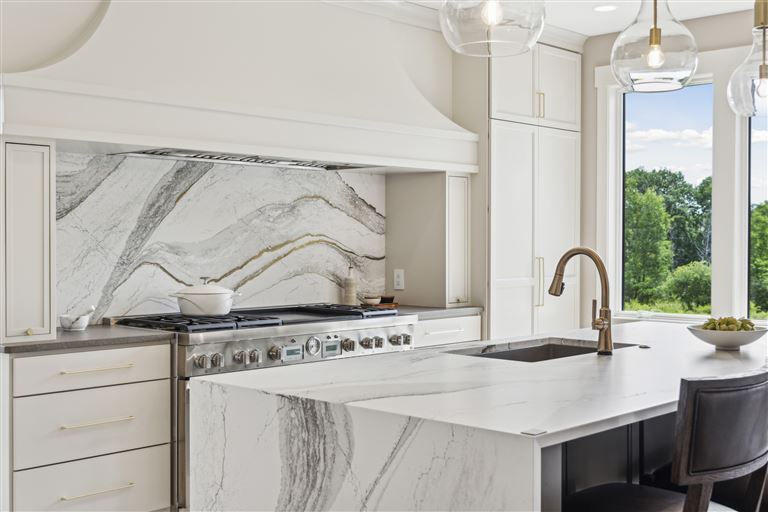 Luxury contemporary kitchen interior with stainless steel appliances and modern furniture.