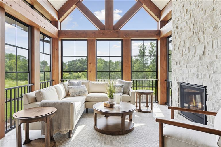 Luxurious contemporary living room with large windows and modern furniture.