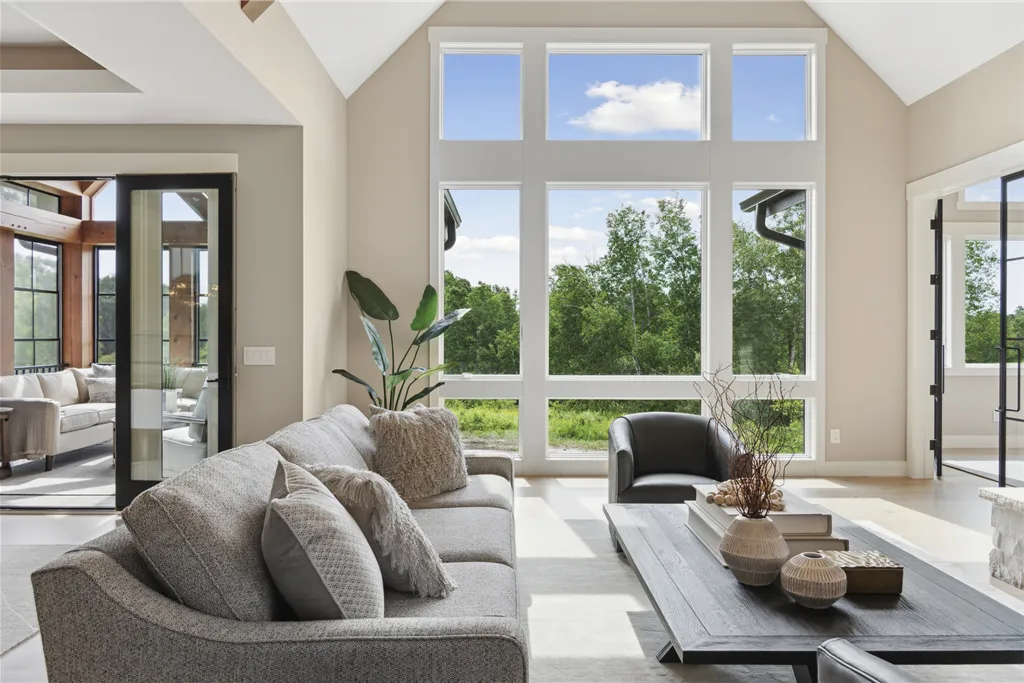Contemporary living room with minimalist design, featuring a sofa, coffee table, and fireplace.