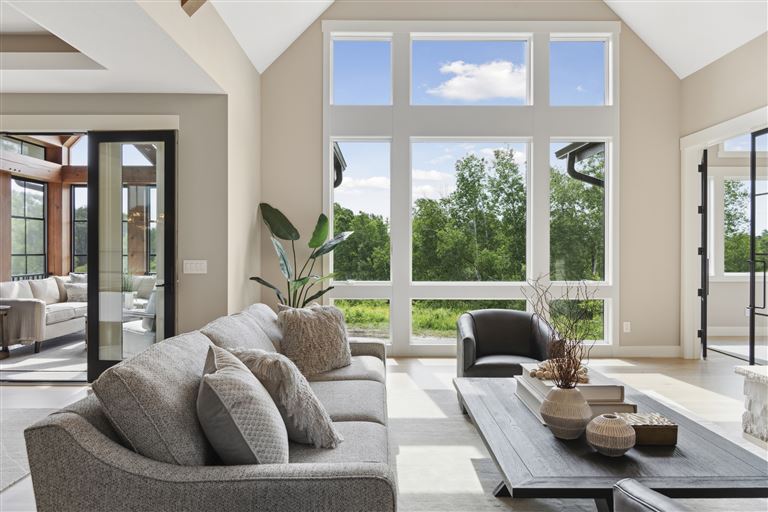 Contemporary living room with minimalist design, featuring a sofa, coffee table, and fireplace.