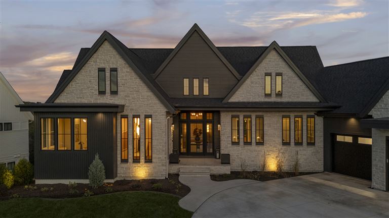 Charming suburban bungalow with lush greenery and classic architecture.