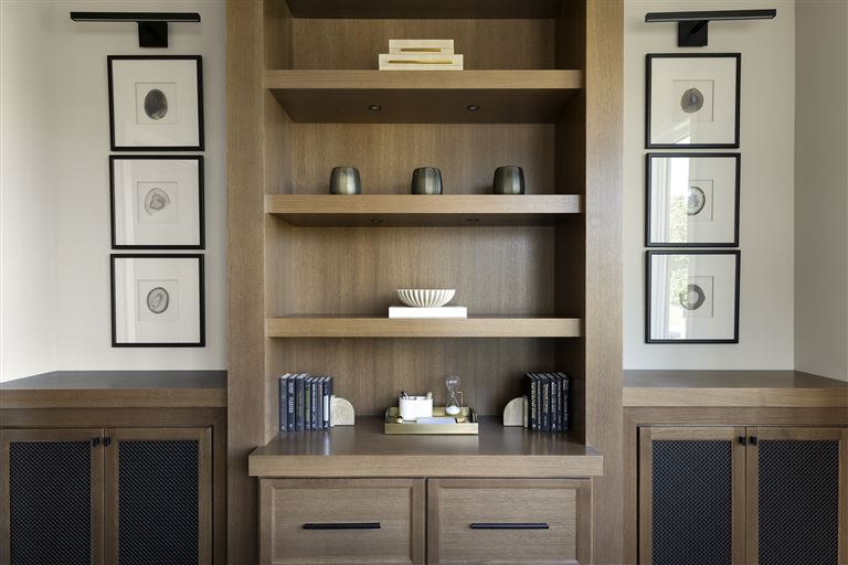 Contemporary minimalist interior with wooden furniture including a shelf, drawer, and cabinet.