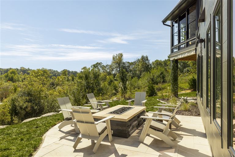 Luxury patio with wooden chairs and table at a beachside hotel.