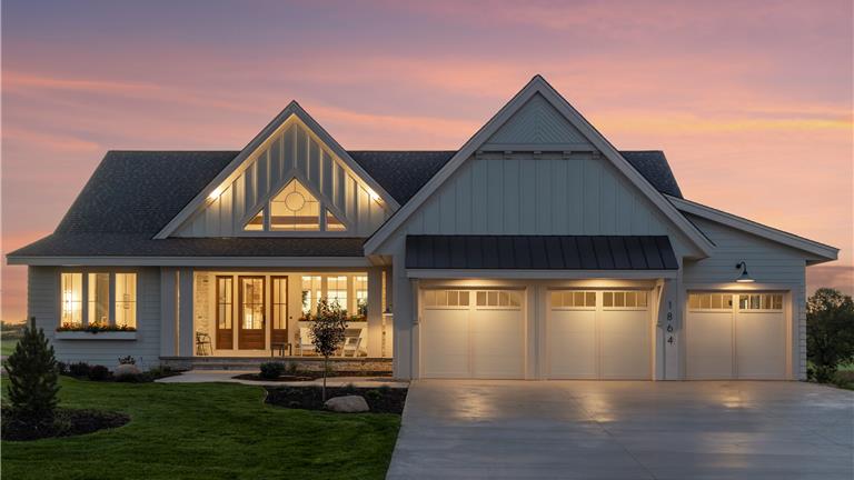 Exterior view of a luxury suburban home with a spacious driveway.