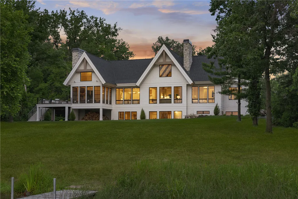 Elegant suburban mansion with a spacious lawn and garden at twilight in Stillwater, MN.