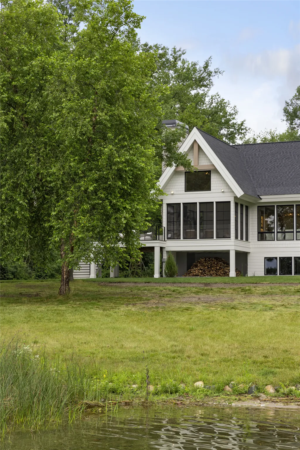 Charming bungalow by Hartman Homes with garden and lake view.