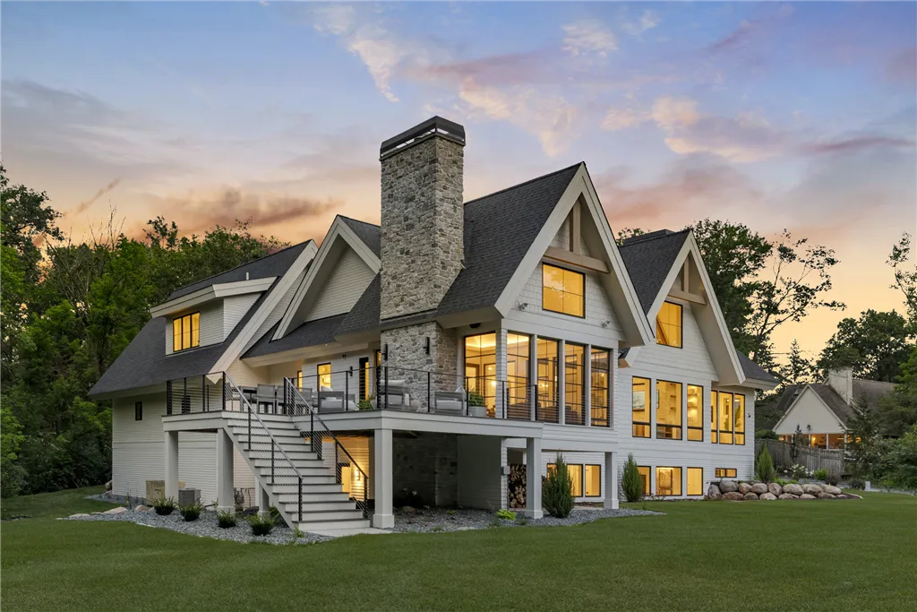 Luxury suburban home in Stillwater, MN at twilight with a spacious driveway and manicured lawn.