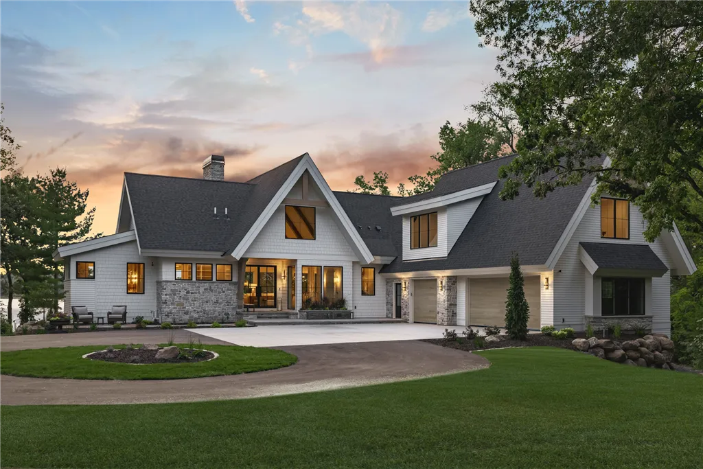 Luxury suburban home with a spacious driveway and manicured lawn in Stillwater, MN.