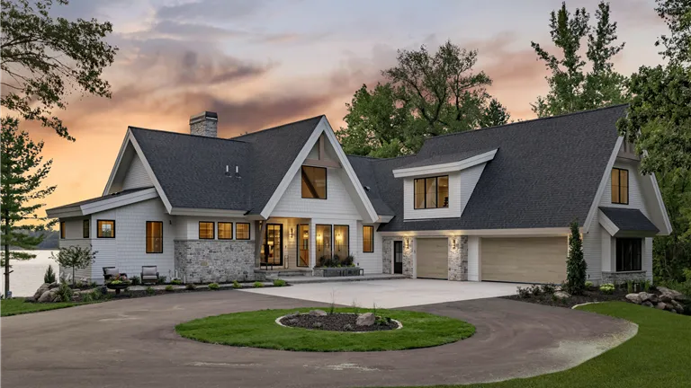 Luxury suburban home in Stillwater, MN at twilight with a spacious driveway and well-maintained lawn.