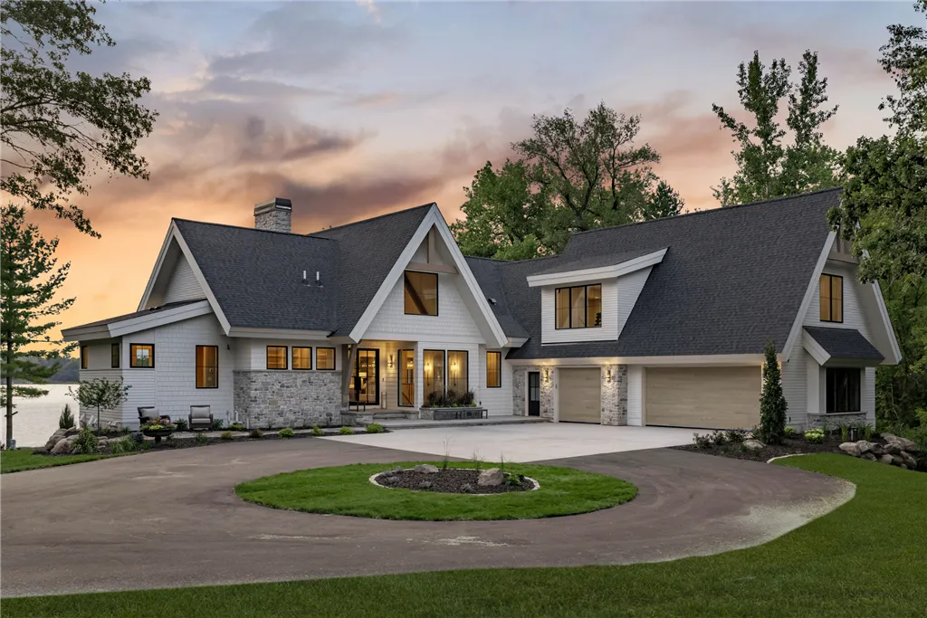 Luxury suburban home in Stillwater, MN at twilight with a spacious driveway and well-maintained lawn.