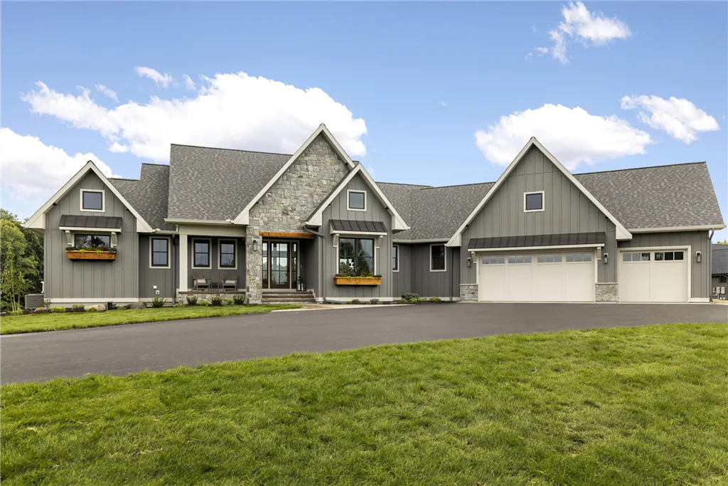 Luxury suburban home with expansive lawn and upscale architecture.