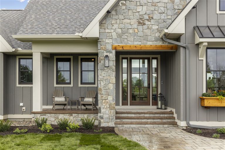 Luxury suburban home with a grand entrance and porch.