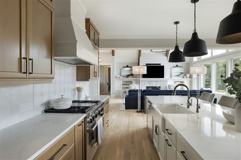 Contemporary minimalist kitchen with stainless steel appliances and modern cabinetry.