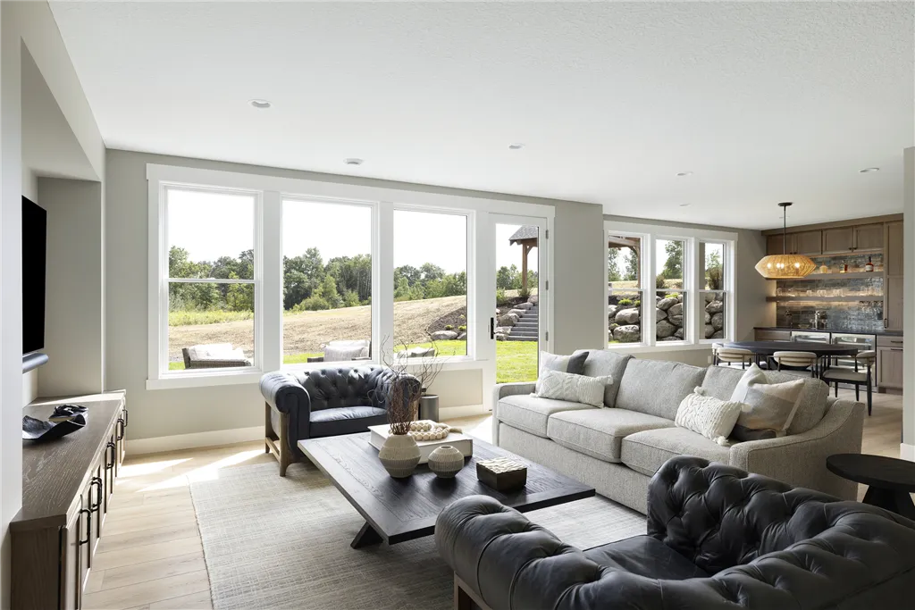 Contemporary living room with sofa, chairs, and coffee table in a luxury apartment.