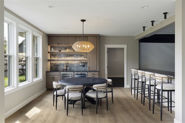 Luxury dining room with contemporary furniture and large windows.