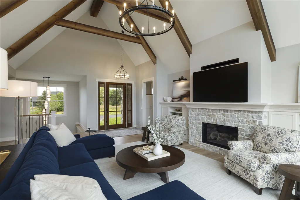 Luxury contemporary living room with sofa, chairs, coffee table, and fireplace.
