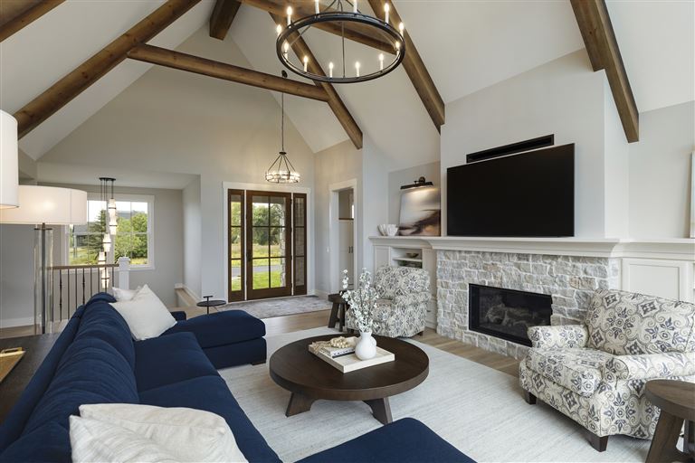 Luxury contemporary living room with sofa, chairs, coffee table, and fireplace.