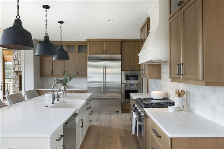 Contemporary minimalist kitchen with stainless steel appliances and modern cabinetry.