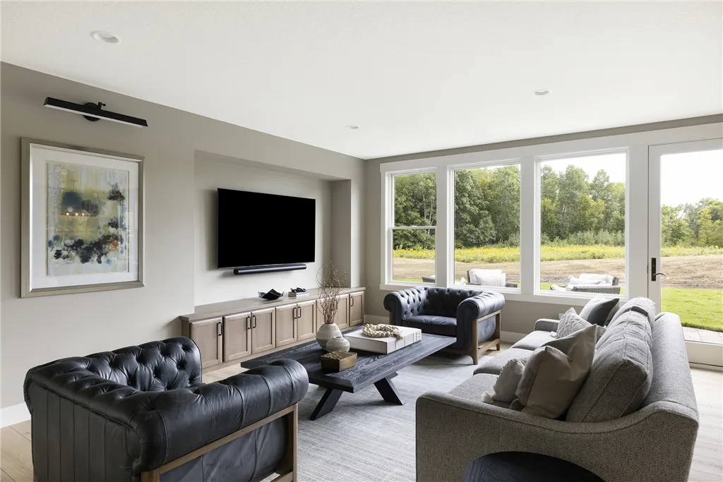 Contemporary minimalist living room with sofa and fireplace by Hartman Homes.