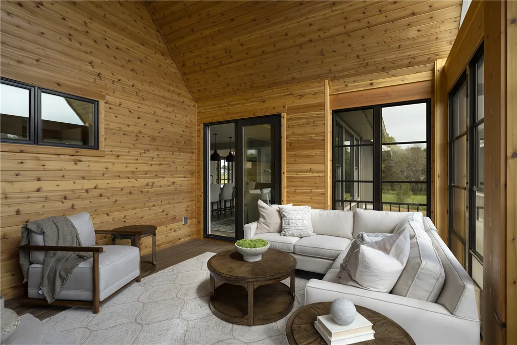Contemporary luxury living room with modern furniture and large windows.