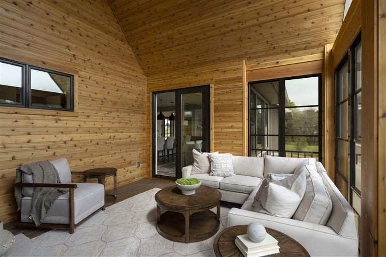 Contemporary luxury living room with modern furniture and large windows.