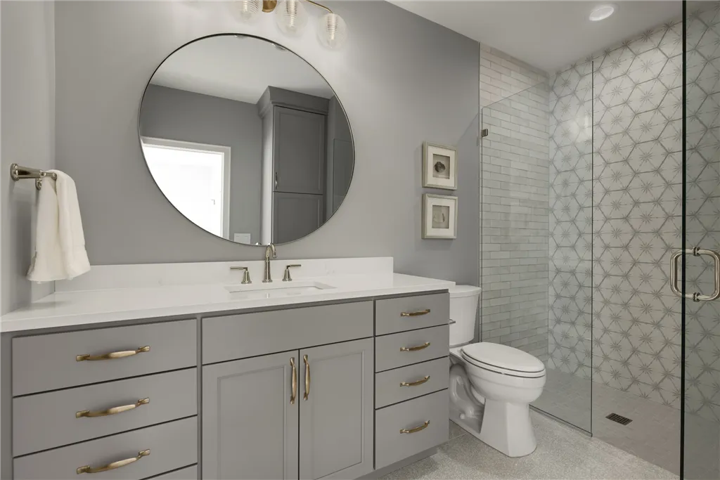 Luxurious contemporary bathroom with bathtub, shower, and modern fixtures by Hartman Homes.