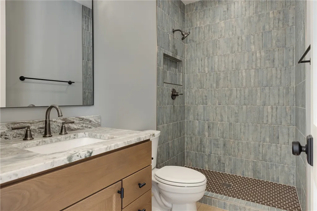 Luxurious contemporary bathroom with bathtub, shower, and minimalist design by Hartman Homes.