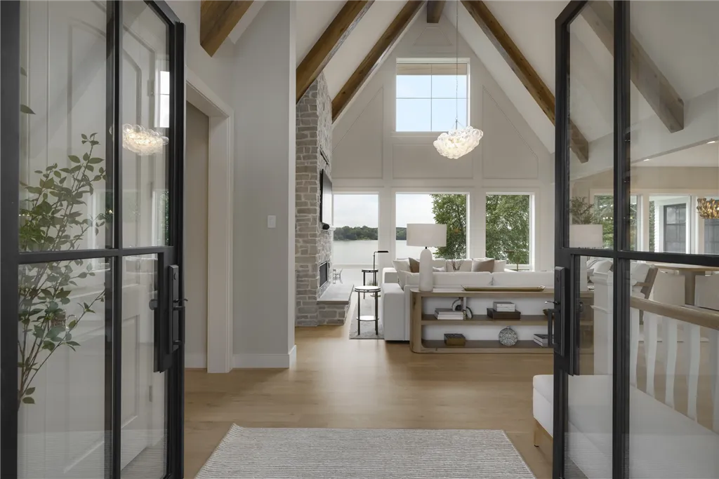 Contemporary minimalist interior design of a spacious home with large windows and luxury seating.