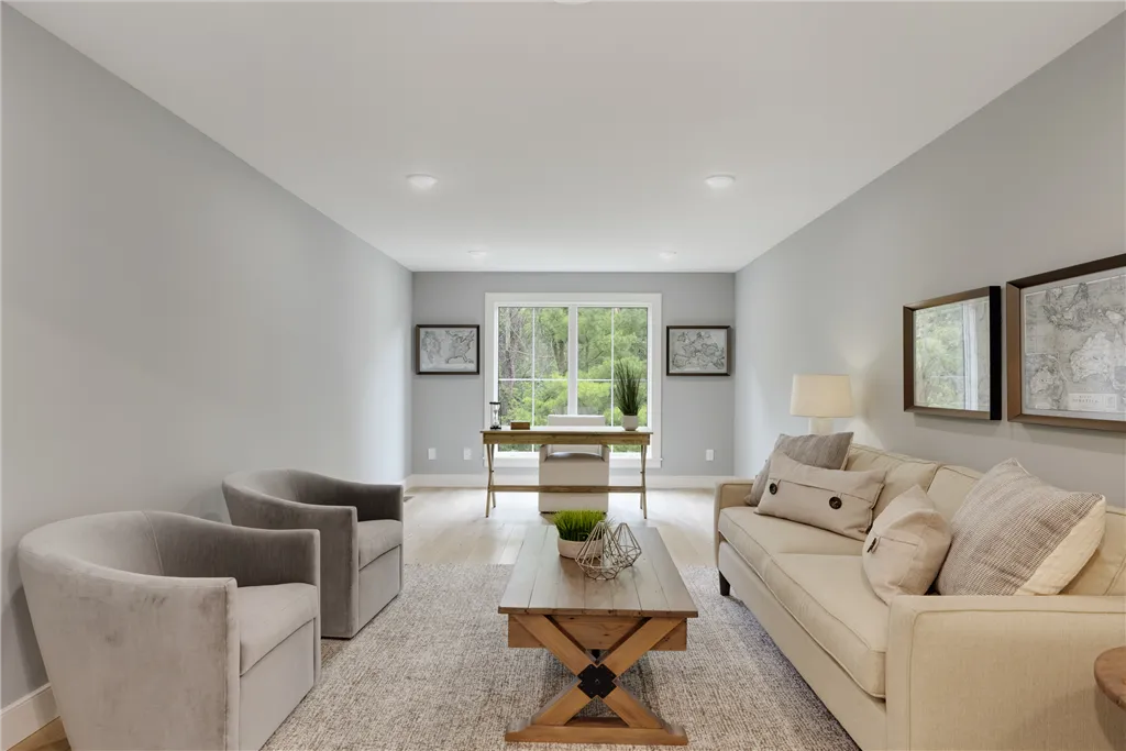 Contemporary family living room with minimalist furniture and large windows.