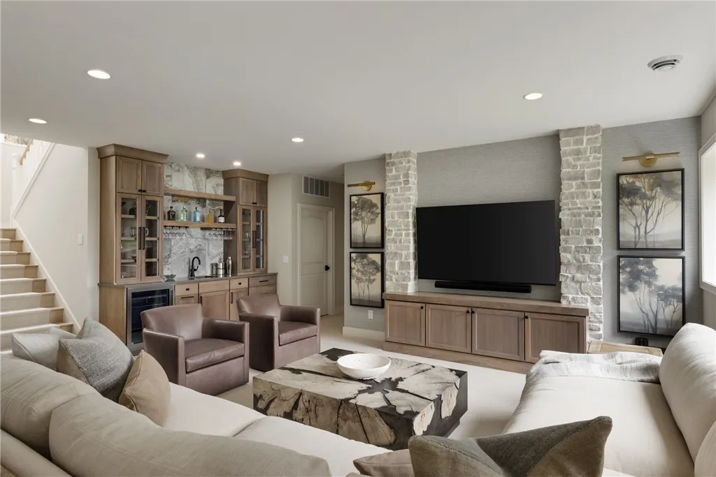 Contemporary living room with sofa, chair, coffee table, and fireplace.