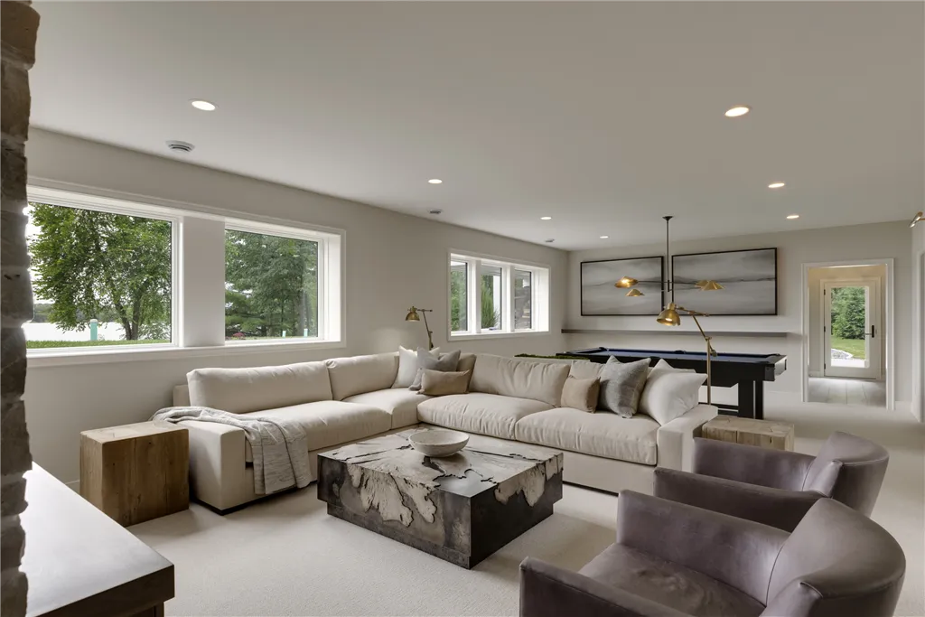 Contemporary minimalist living room with luxury furniture including a sofa, easy chair, and coffee table.