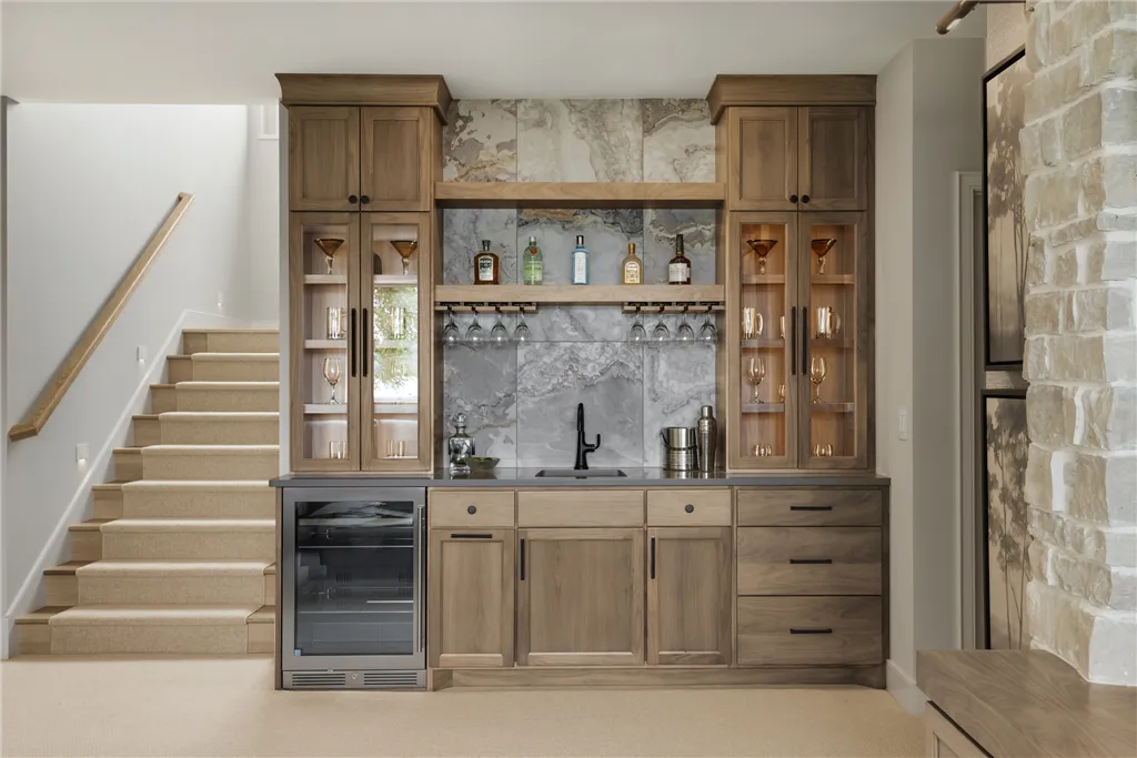 Contemporary minimalist interior with wooden cabinetry and mirror.