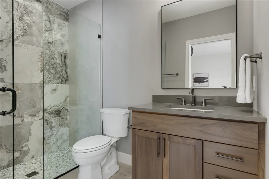 Contemporary luxury bathroom with minimalist design, featuring a bathtub, faucet, and mirror.