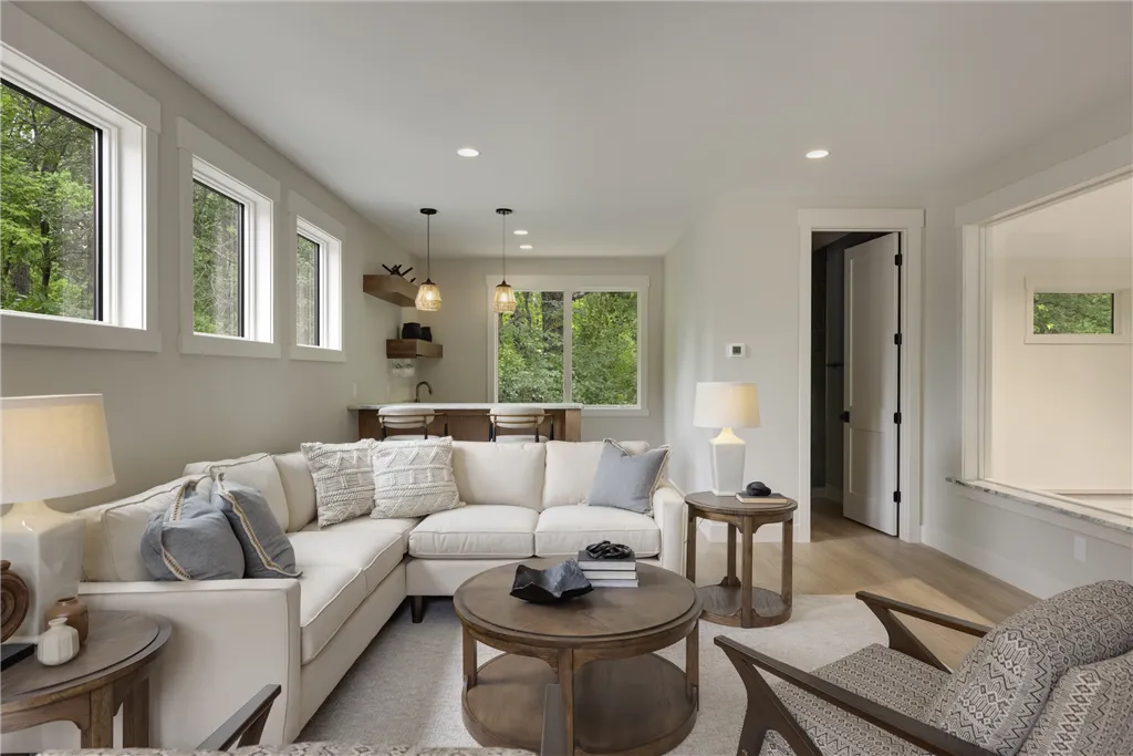 Contemporary family room with sofa, coffee table, and fireplace.