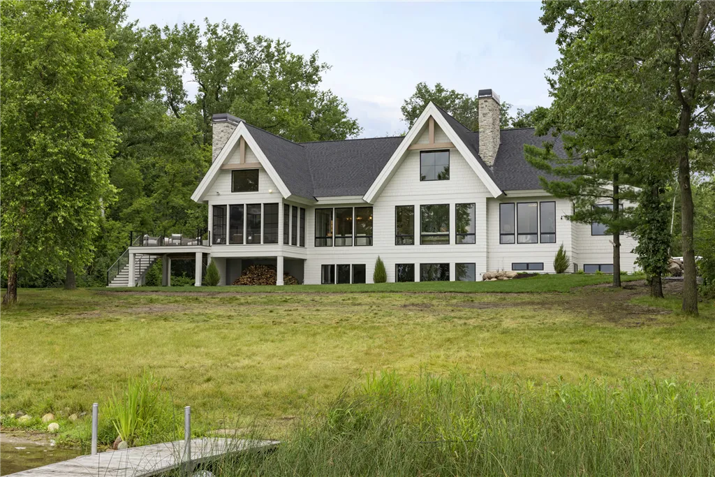 Charming suburban bungalow with a spacious lawn and driveway.