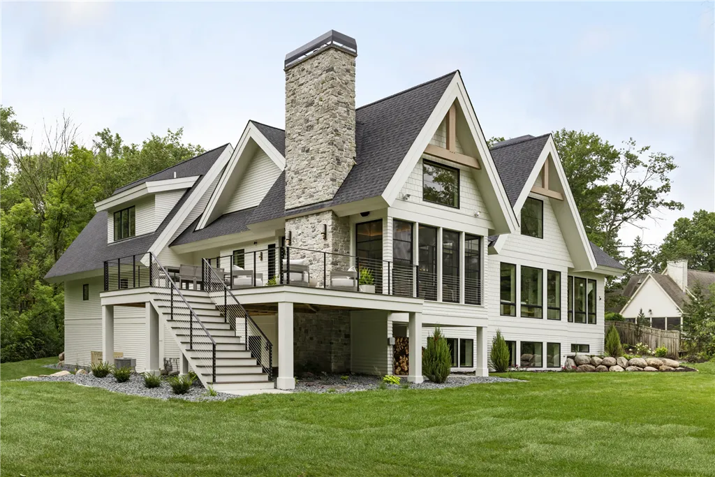 Luxury suburban home with a spacious driveway and well-maintained lawn.