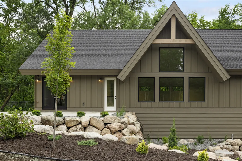 Charming suburban bungalow with a lush garden and driveway.