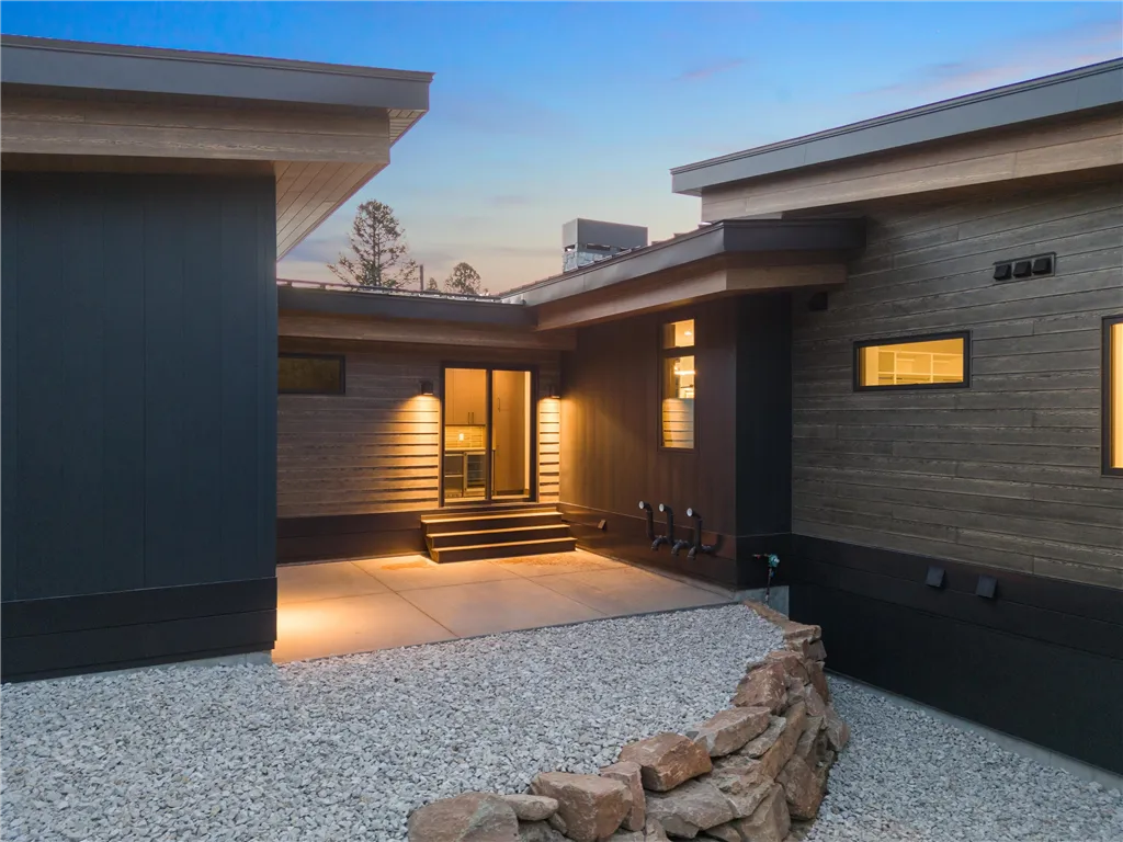 Interior of a luxury contemporary home with a fireplace and patio view.