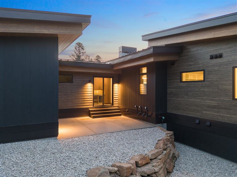 Interior of a luxury contemporary home with a fireplace and patio view.