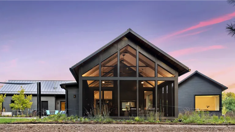 Exterior view of a modern luxury home with garage and windows.