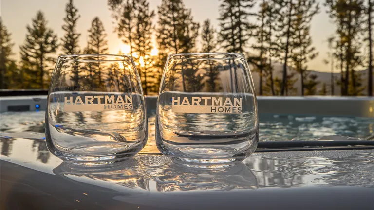 Reflection of a sunset on icy water with a clear sky.