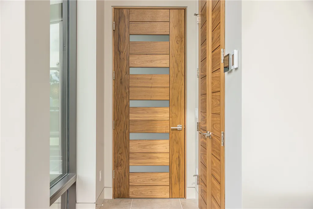 Contemporary wooden door in a classic interior design setting.